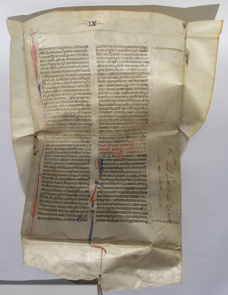 The 'Justinian Wrapper' partly unwrapped, with the exterior of the folder (that is, the original recto of the medieval leaf with part of the Emperor Justinian's 'Novels' (or 'Novellae Constitutiones'), showing its full two columns of text and most of its original margins, above the pasted flap at the bottom. Photography © Mildred Budny