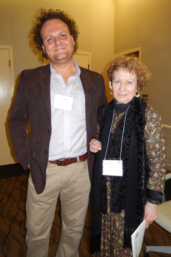 Two Attendees at the 2015 Reception at the 50th International Congress on Medieval Studies. They stand facing the photographer and smile. Photography © Mildred Budny 