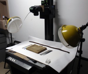 The Medieval-Psalter-Covered French Notebook in course of photography, archivally-sensitive equipment in place. Vire from the front cover, with untied ties. Photography © Mildred Budny. Reproduced by permission.