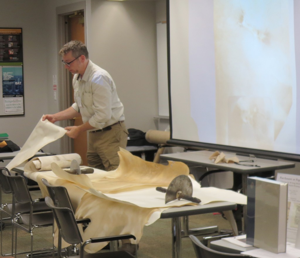Jesse Meyer demonstrates different types of prepared parchment and tools for the 'Paper or Parchment' Session at the 2016 International Congress on Medieval Studies. Photography © Mildred Budny