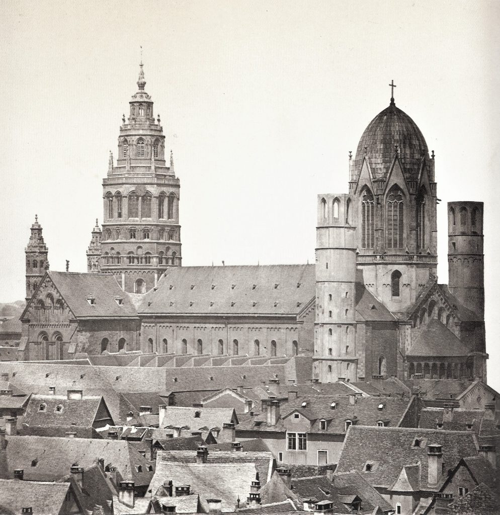 Mainz Cathedral from SE before 1858. Photograph published by Hermann Emden (1858). Public Domain, via Wikimedia Commons. 