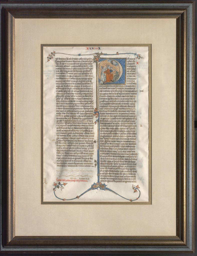 The medieval leaf written on vellum is enclosed within a windowed mat and frame.