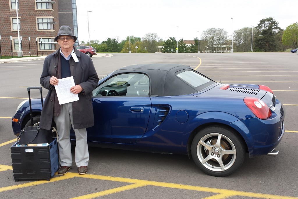 Geoffrey Russom stands beside his car in the parking lot behind Fetzer at the 51st International Congress on Medieval Studies. Photography The Speakers Respond at the 'Magic on the Page' Session at the 2016 International Congress on Medieval Studies. Poster set in RGME Bembino. Photography © Mildred Budny.