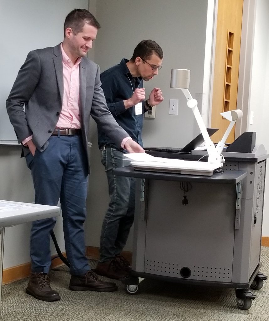 Eric and Ian Check the Projection for their Joint Paper at the 2019 Congress.